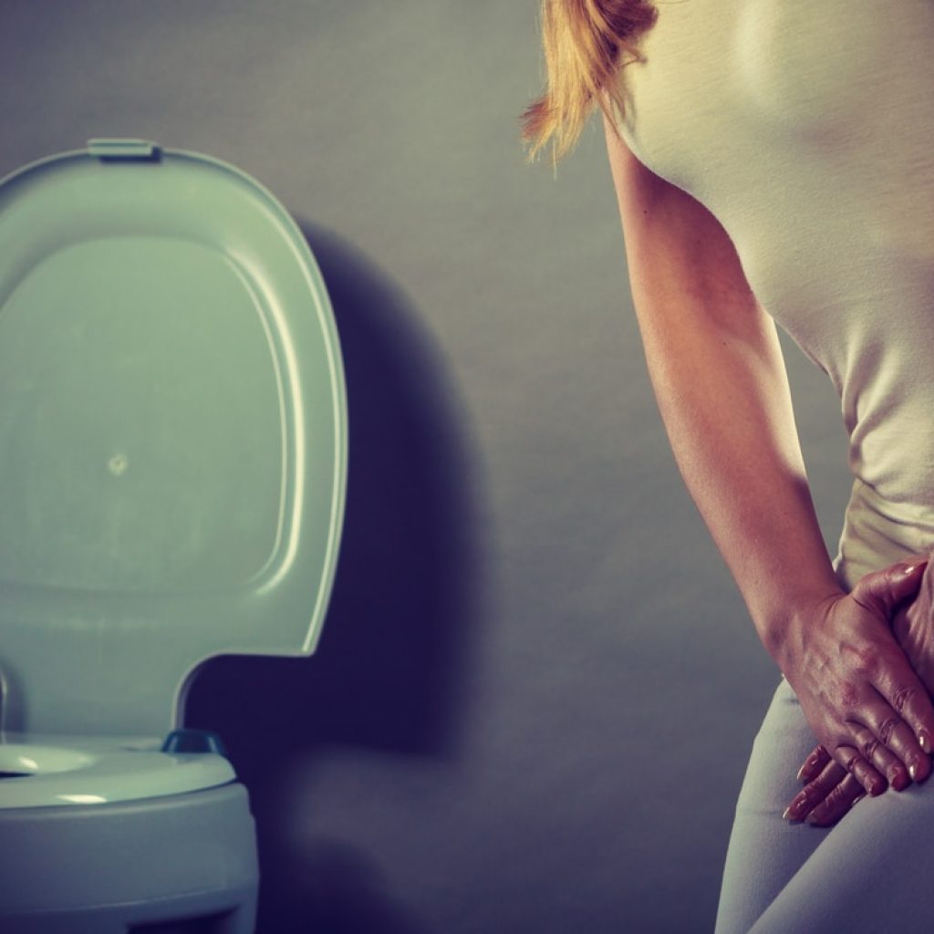 woman with hands holding her crotch